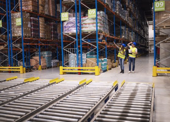 Warehouse workers checking inventory and goods distribution in large storehouse. Warehouse workers checking inventory and goods distribution in large storehouse.